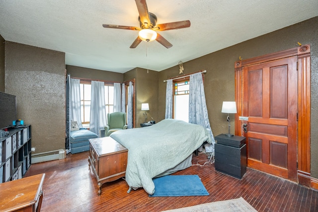 bedroom with multiple windows, ceiling fan, dark hardwood / wood-style flooring, and a baseboard radiator