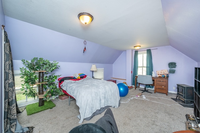 bedroom featuring carpet, lofted ceiling, and a wood stove