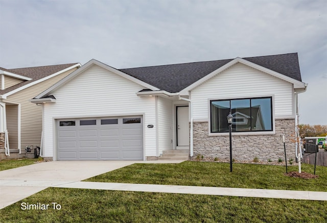 view of front of home with a front yard and a garage