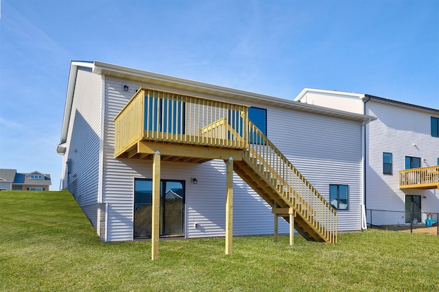 rear view of property with stairs, a yard, and a wooden deck