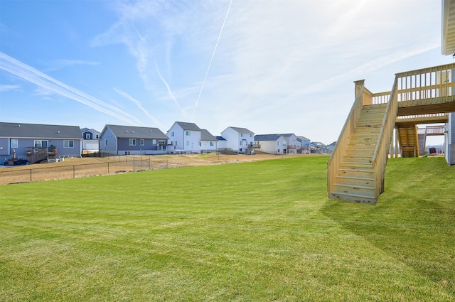 view of yard featuring a residential view and stairway