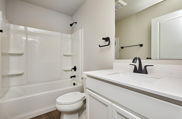 bathroom featuring shower / bathtub combination, toilet, wood finished floors, and vanity