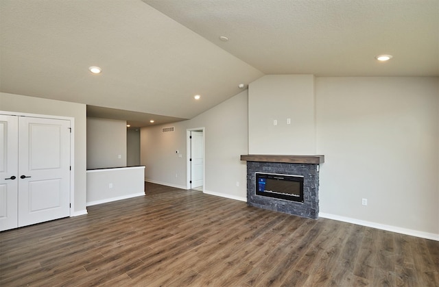 unfurnished living room featuring baseboards, wood finished floors, a fireplace, and vaulted ceiling