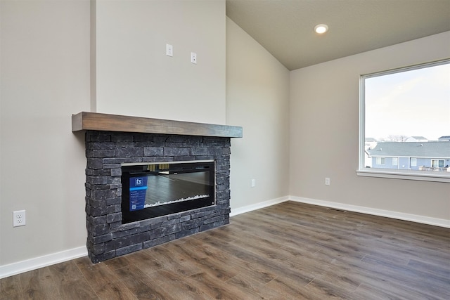 room details featuring wood finished floors, baseboards, visible vents, recessed lighting, and a fireplace