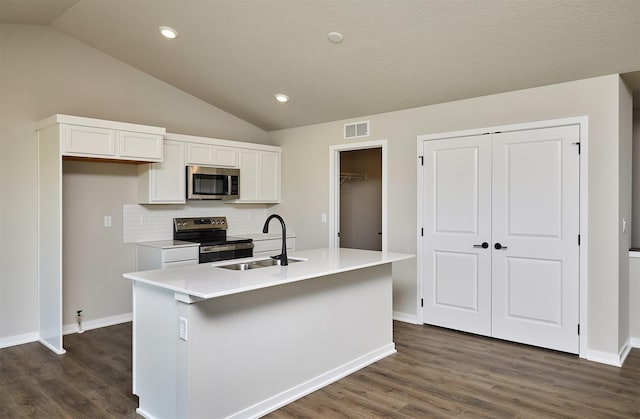 kitchen with a sink, visible vents, appliances with stainless steel finishes, and white cabinets