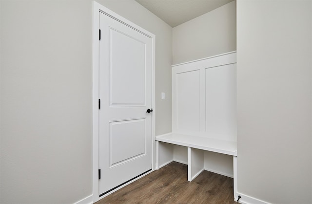 mudroom with dark wood-style floors and baseboards