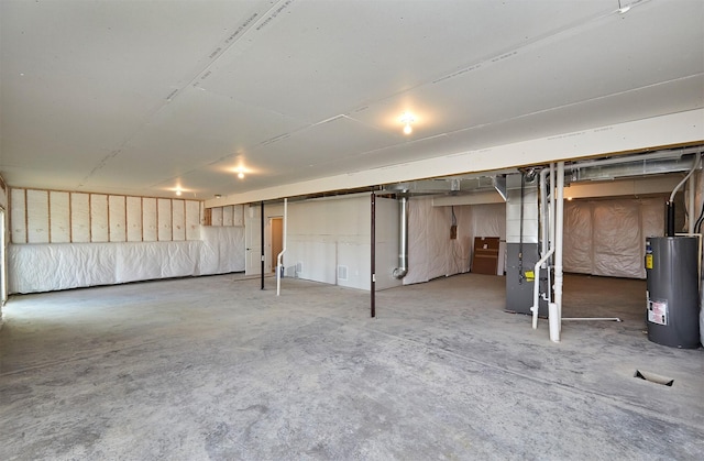 unfinished basement with heating unit and electric water heater