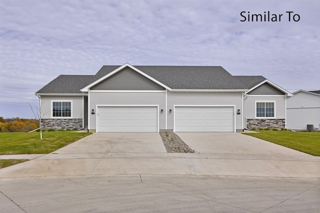 view of front of home featuring a front lawn and a garage