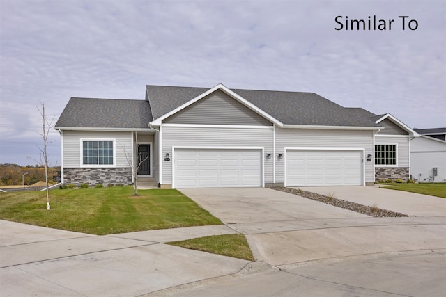 view of front of property with a garage and a front lawn