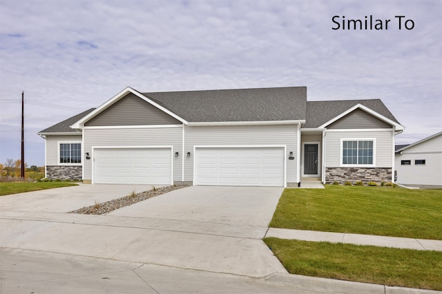 view of front of property with a garage and a front lawn