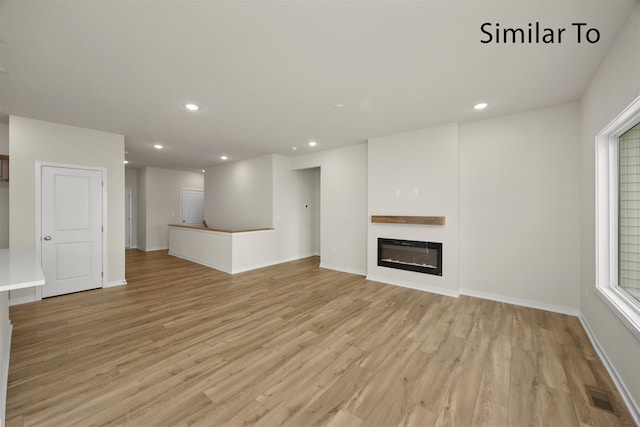 unfurnished living room with light hardwood / wood-style flooring