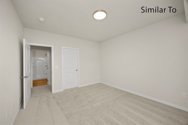 unfurnished bedroom featuring light colored carpet