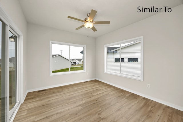 spare room featuring light wood-type flooring and ceiling fan