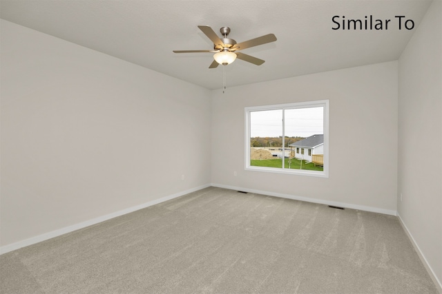 spare room featuring ceiling fan and light colored carpet