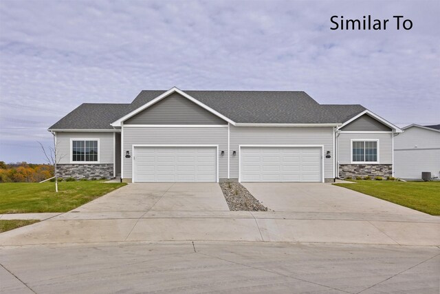 view of front of home with a front lawn and a garage