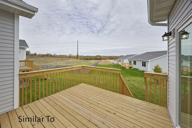 wooden terrace with a lawn