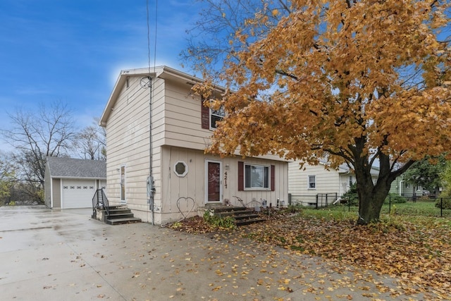 view of front facade featuring a garage and an outbuilding