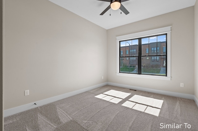 spare room featuring carpet flooring and ceiling fan