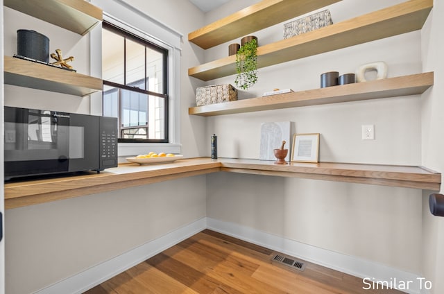 interior space with hardwood / wood-style floors and butcher block counters