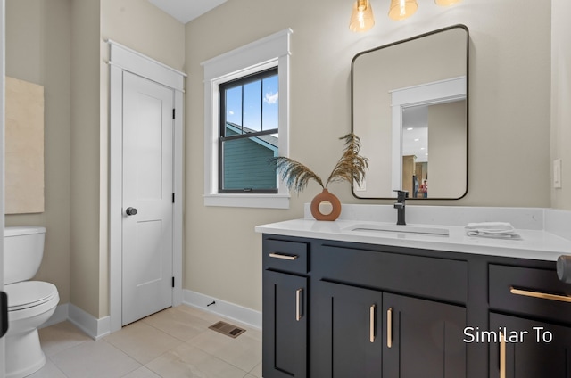 bathroom with tile patterned floors, vanity, and toilet