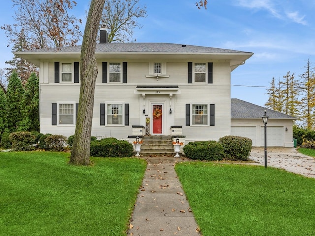 view of front facade with a front yard and a garage