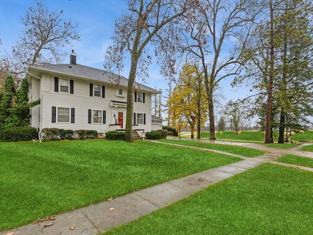 colonial inspired home featuring a front lawn