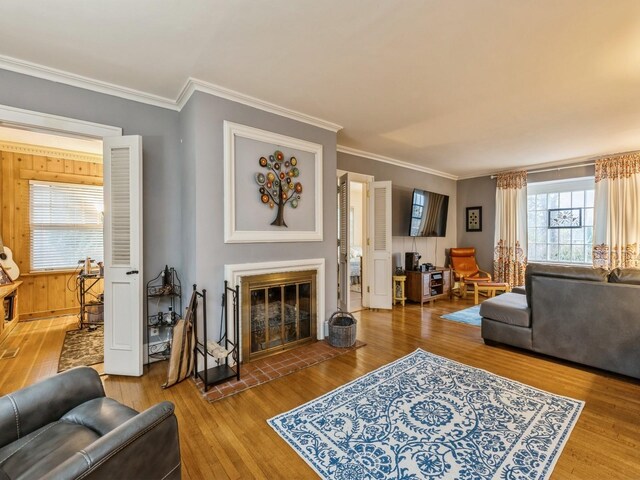 living room with hardwood / wood-style floors and crown molding