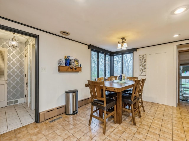 dining room with baseboard heating and a chandelier