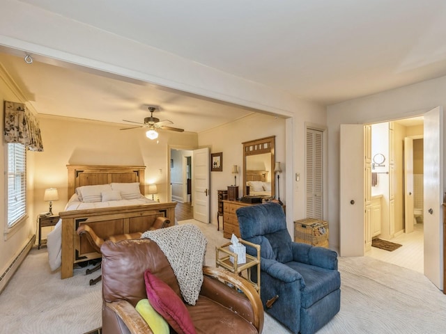 bedroom with ensuite bath, light colored carpet, baseboard heating, and ceiling fan