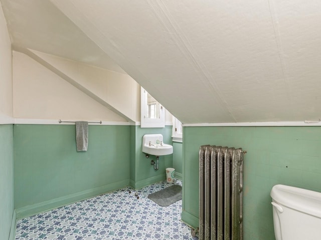 bathroom featuring toilet, sink, and radiator