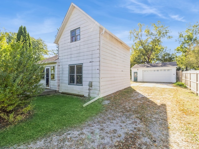 view of property exterior featuring a lawn and an outbuilding