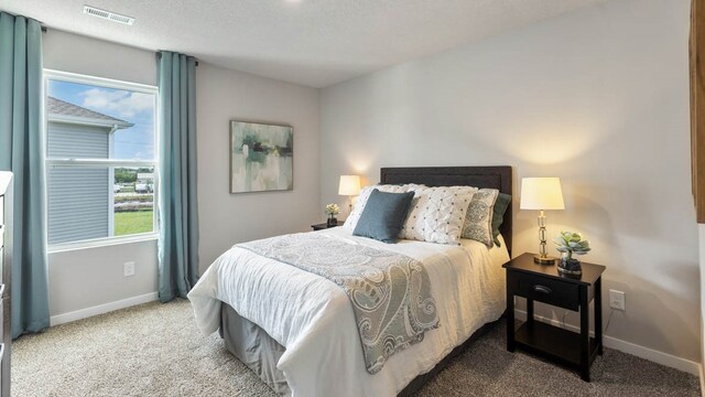 carpeted bedroom with a textured ceiling