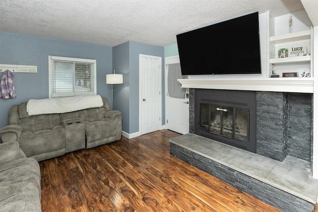 living room featuring dark wood-type flooring and a textured ceiling