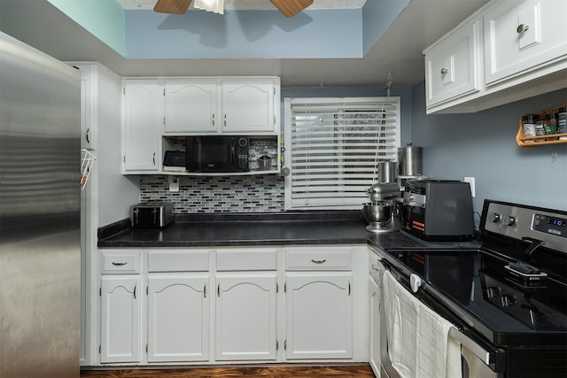 kitchen with stainless steel appliances, tasteful backsplash, white cabinets, and ceiling fan