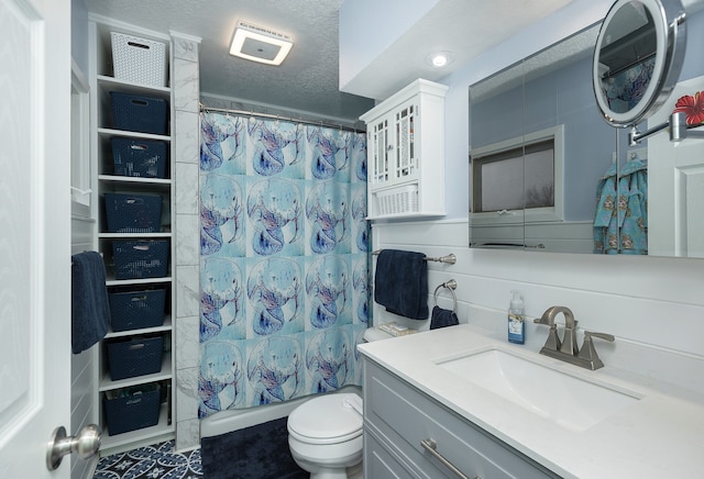 bathroom featuring vanity, toilet, a shower with shower curtain, and a textured ceiling