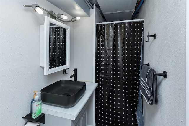 bathroom featuring sink and curtained shower