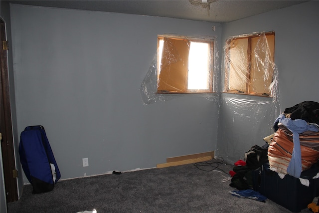 carpeted empty room featuring a textured ceiling