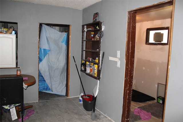 hallway featuring a textured ceiling