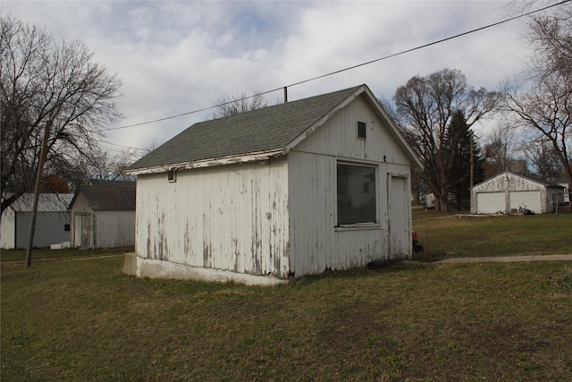 view of home's exterior with an outdoor structure and a yard