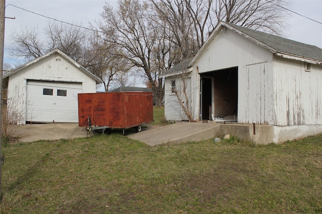 exterior space featuring a garage and an outdoor structure