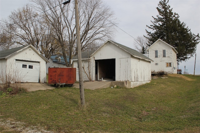 view of outbuilding with a lawn and a garage