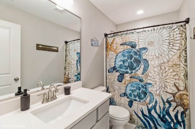 bathroom featuring vanity and toilet