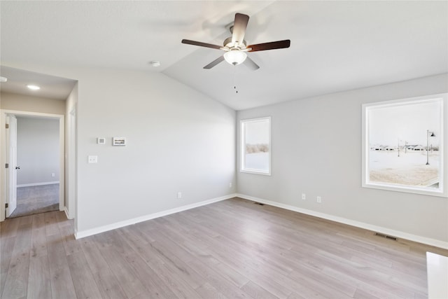 unfurnished room featuring vaulted ceiling, ceiling fan, and light wood-type flooring