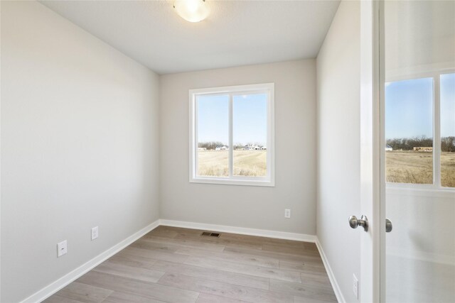 unfurnished room featuring light hardwood / wood-style floors