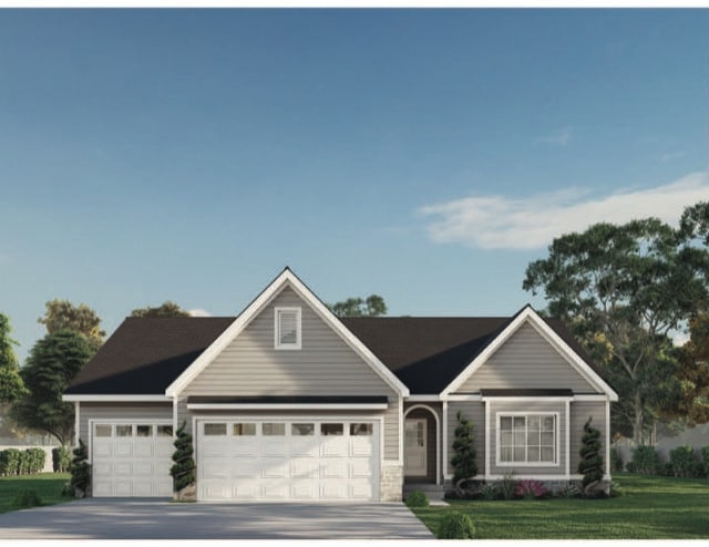 view of front of home featuring a garage and a front lawn