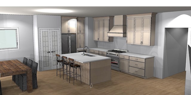 kitchen featuring stainless steel appliances, sink, wall chimney range hood, a center island with sink, and a breakfast bar area