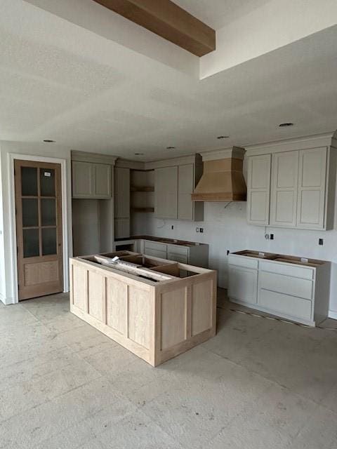 kitchen featuring custom exhaust hood and a center island