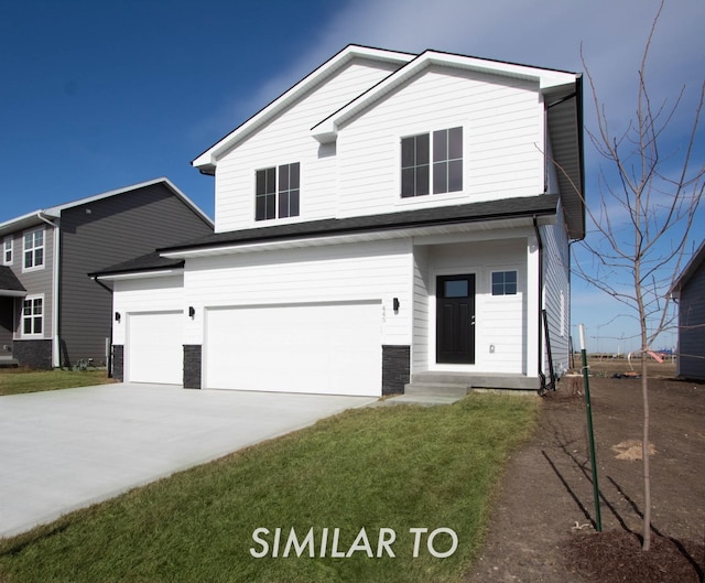 front of property with a garage and a front lawn