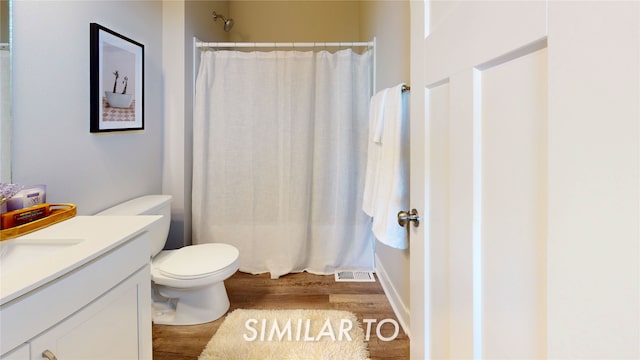 bathroom featuring hardwood / wood-style flooring, vanity, toilet, and a shower with shower curtain