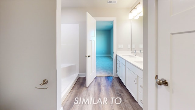 bathroom with vanity and hardwood / wood-style floors